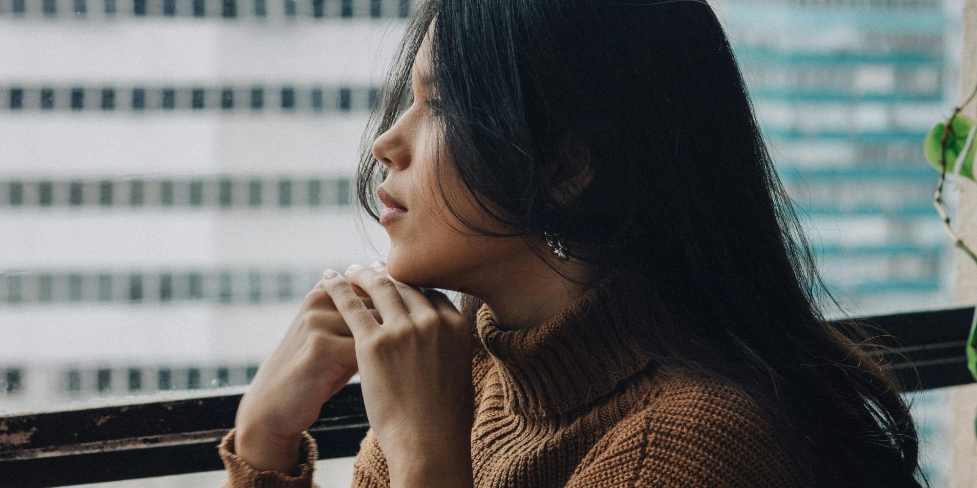 woman looking out the window